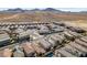 An aerial view shows desert homes in a planned community, some with pools, set against a mountain backdrop at 3192 Bormida Ave, Henderson, NV 89044