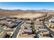 Aerial view of desert homes showcases community layout, mountain views, and a bright blue sky at 3192 Bormida Ave, Henderson, NV 89044
