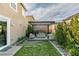 Cozy backyard features a pergola-covered seating area and lush landscaping, perfect for relaxation at 3192 Bormida Ave, Henderson, NV 89044