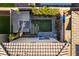 An aerial view of a backyard with a small lawn, xeriscaping, a covered patio, and stepping stones at 3192 Bormida Ave, Henderson, NV 89044