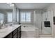 Clean bathroom featuring dual sinks, soaking tub, and a shower at 3192 Bormida Ave, Henderson, NV 89044