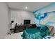 Whimsical bedroom featuring a vibrant accent wall and a plush, teal-colored bed at 3192 Bormida Ave, Henderson, NV 89044