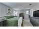 Bedroom featuring calming green bedding, shutters, and dark furniture at 3192 Bormida Ave, Henderson, NV 89044