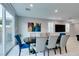 Dining room with seating for eight, a large window, and stylish artwork at 3192 Bormida Ave, Henderson, NV 89044