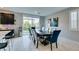 Bright dining room with a large window, a modern chandelier and luxury finishes at 3192 Bormida Ave, Henderson, NV 89044