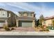 A well-kept home features a brick paver driveway, manicured desert landscaping, and a neutral color palette at 3192 Bormida Ave, Henderson, NV 89044