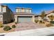 Charming two-story home with a two-car garage, tile roof, desert landscaping, and a brick paver driveway at 3192 Bormida Ave, Henderson, NV 89044