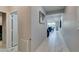 Hallway with white marble flooring and a view of the open plan dining area at 3192 Bormida Ave, Henderson, NV 89044