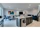 Modern kitchen with stainless appliances, a large island, and open access to the dining and living areas at 3192 Bormida Ave, Henderson, NV 89044