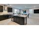 Spacious kitchen with dark cabinets, an island and stainless steel appliances at 3192 Bormida Ave, Henderson, NV 89044
