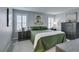 The main bedroom featuring calm decor, an artistic accent wall and large windows at 3192 Bormida Ave, Henderson, NV 89044