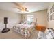 Serene bedroom with a plush floral bed, ceiling fan, and comfortable seating at 3192 Taylor St, Logandale, NV 89021