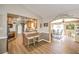 Bright dining room with wood floors, arched entryway, and adjacent kitchen at 3192 Taylor St, Logandale, NV 89021