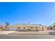 Charming single-story home featuring a gravel yard and a tile roof under a clear blue sky at 3192 Taylor St, Logandale, NV 89021