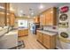 Bright eat-in kitchen features wood cabinets and a black refrigerator at 3192 Taylor St, Logandale, NV 89021