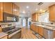 Modern kitchen featuring wooden cabinetry, stainless steel appliances, and ample counter space at 3192 Taylor St, Logandale, NV 89021