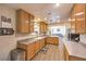 Eat-in kitchen showcases wood cabinets and laminate flooring at 3192 Taylor St, Logandale, NV 89021