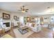 Spacious living room features a fireplace, ceiling fan, wood flooring, and neutral decor at 3192 Taylor St, Logandale, NV 89021