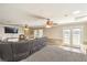 Spacious living room with gray carpeting and double glass doors to the backyard at 3192 Taylor St, Logandale, NV 89021