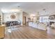 Bright living room featuring a fireplace, ceiling fan, wood flooring, and comfortable seating at 3192 Taylor St, Logandale, NV 89021