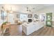 Open living room featuring a fireplace, ceiling fan, wood flooring, and neutral decor at 3192 Taylor St, Logandale, NV 89021