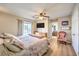 Cozy main bedroom boasts ample natural light, ensuite bathroom, and ceiling fan at 3192 Taylor St, Logandale, NV 89021