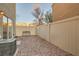 Cozy backyard area featuring gravel, a charming bench, and a secure fence for privacy at 3411 Holly Ave, Las Vegas, NV 89106