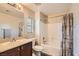 Bathroom featuring a single sink, vanity with storage, and a shower-tub combo at 3411 Holly Ave, Las Vegas, NV 89106