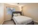 Comfortable bedroom with a queen-sized bed, natural light, and hardwood flooring, offering a cozy retreat at 3411 Holly Ave, Las Vegas, NV 89106