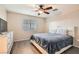 Bright bedroom featuring a queen-sized bed, a ceiling fan and natural lighting from a window with blinds at 3411 Holly Ave, Las Vegas, NV 89106