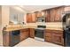 Cozy kitchen with wooden cabinets, granite countertops, and stainless steel appliances for easy meal preparation at 3411 Holly Ave, Las Vegas, NV 89106