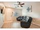 Well-lit living room features light hardwood floors, modern fan, and a comfortable, reclining leather sofa at 3411 Holly Ave, Las Vegas, NV 89106