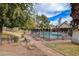 Inviting community pool area with lush landscaping, mature trees, and clear blue skies at 3449 Lorilou Ln # 2, Las Vegas, NV 89121