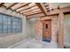Inviting home entrance with a unique wooden door, brick accents and covered patio area at 3449 Lorilou Ln # 2, Las Vegas, NV 89121