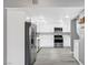 Updated kitchen with stainless steel appliances, white cabinets, and modern lighting at 3449 Lorilou Ln # 2, Las Vegas, NV 89121