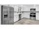 Bright kitchen features stainless steel appliances, modern fixtures, and white cabinetry at 3449 Lorilou Ln # 2, Las Vegas, NV 89121