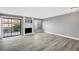 Spacious living room boasting wood floors, natural light, and cozy fireplace at 3449 Lorilou Ln # 2, Las Vegas, NV 89121