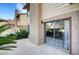 Outdoor patio with sliding glass doors and minimal landscaping to the side at 3449 Lorilou Ln # 2, Las Vegas, NV 89121