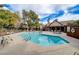 Community pool area with lounge chairs and a clubhouse under a blue sky at 3449 Lorilou Ln # 2, Las Vegas, NV 89121