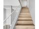 The staircase has light wood steps and white railings at 3449 Lorilou Ln # 2, Las Vegas, NV 89121