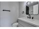 This bathroom features modern fixtures, black hardware, and a bright white vanity at 3484 Nightflower Ln # B, Las Vegas, NV 89121