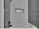 This tiled bathroom features a shower and tub combination, and a built-in shower niche at 3484 Nightflower Ln # B, Las Vegas, NV 89121