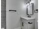 This is a clean bathroom with a modern vanity, black fixtures, and a decorative mirror at 3484 Nightflower Ln # B, Las Vegas, NV 89121