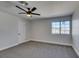 This bedroom features neutral walls, carpeted floors, and a dark-colored ceiling fan at 3484 Nightflower Ln # B, Las Vegas, NV 89121