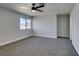 This bright bedroom features neutral walls, carpeted floors, and a ceiling fan at 3484 Nightflower Ln # B, Las Vegas, NV 89121