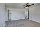 This bedroom features neutral walls, carpeted floors, access to an ensuite and ceiling fan at 3484 Nightflower Ln # B, Las Vegas, NV 89121