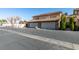 Two-story home exterior featuring multiple garages and an asphalt driveway at 3484 Nightflower Ln # B, Las Vegas, NV 89121