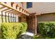 Charming front entryway with a wood pergola, brick accents, and lush greenery, creating a welcoming entrance at 3484 Nightflower Ln # B, Las Vegas, NV 89121