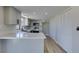 Bright kitchen featuring white cabinets, quartz countertops, stainless appliances, and wood-look tile flooring at 3484 Nightflower Ln # B, Las Vegas, NV 89121