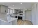 Updated kitchen with grey cabinets, stainless steel appliances, quartz countertops, and new flooring at 3484 Nightflower Ln # B, Las Vegas, NV 89121